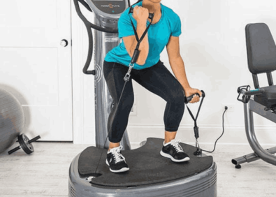 Engaging in a Power Plate training session, utilizing whole body vibration technology for muscle strengthening and fat reduction